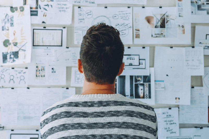 man sitting in front of a wall